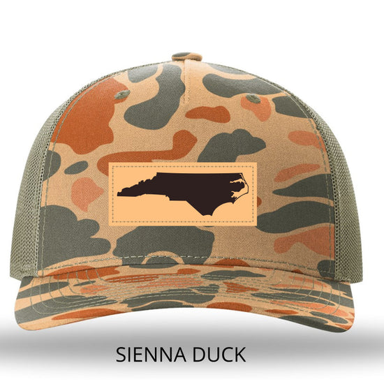 NC Outline Rectangle Leather Patch -Sienna Duck Camo/Loden Richardson 112PFP Snapback Trucker Hat Lost Wando Outfitters